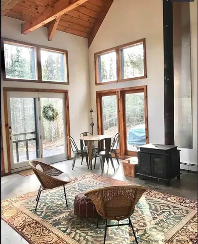 a dining room with furniture a rug and a large window