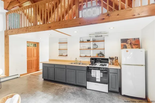 a kitchen with stainless steel appliances granite countertop a refrigerator and a stove