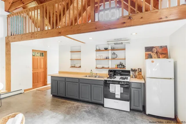 a kitchen with stainless steel appliances granite countertop a refrigerator and a stove