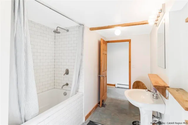 a bathroom with a bathtub and a sink