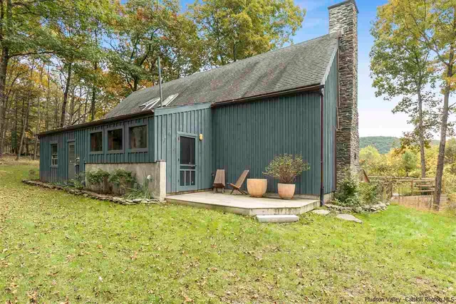 a front view of house with yard outdoor seating and garage