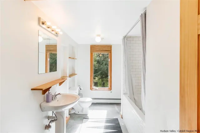 a bathroom with a sink a mirror and a window