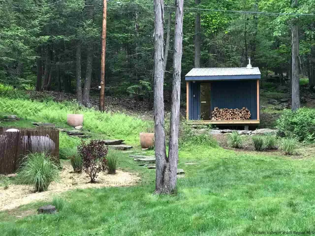 a view of a chair and table in backyard of the house