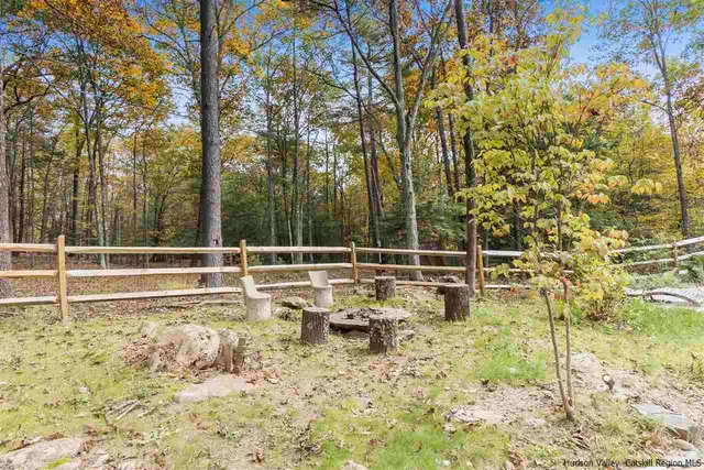 a view of a yard with wooden fence