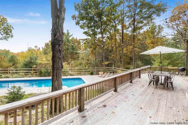 a view of a balcony with wooden floor and lake view