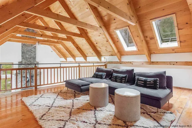 a reading room with furniture and a wooden floor