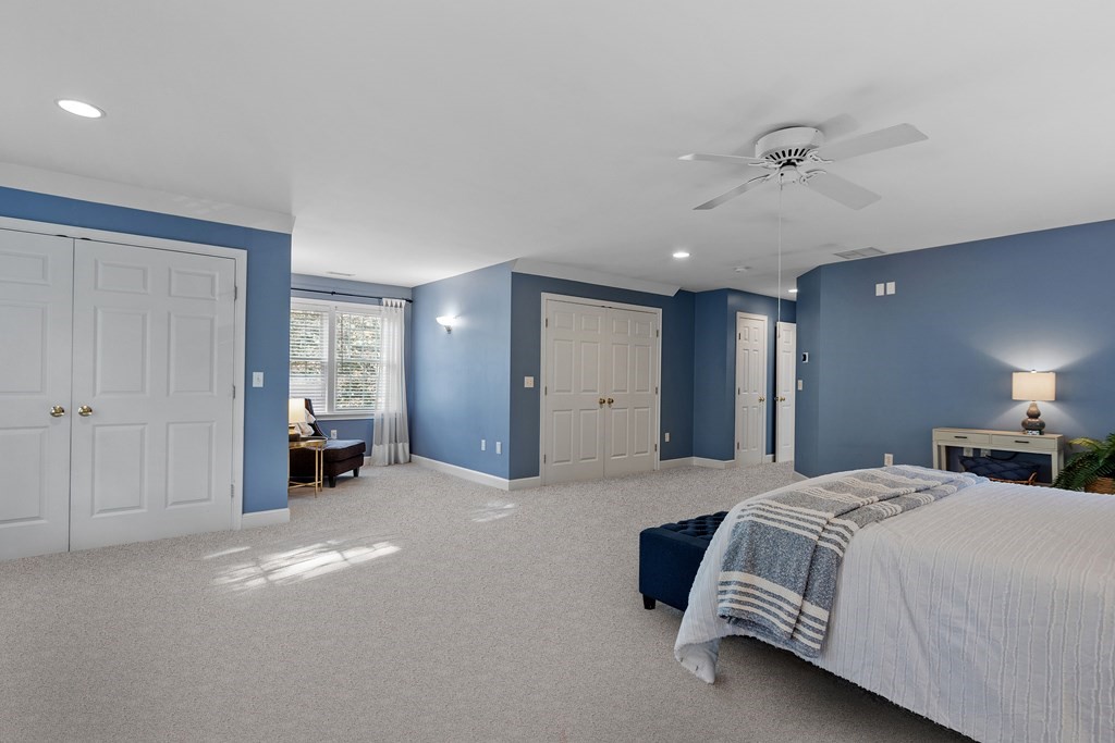 298 Old Harvard Road Boxborough, MA 01719 - Photo 21 of 42 a spacious bedroom with a bed and a lamp