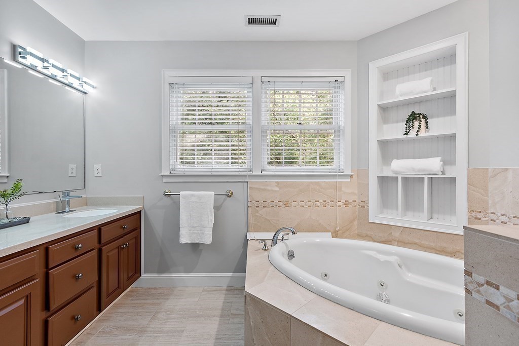 298 Old Harvard Road Boxborough, MA 01719 - Photo 22 of 42 a bathroom with a tub sink and mirror