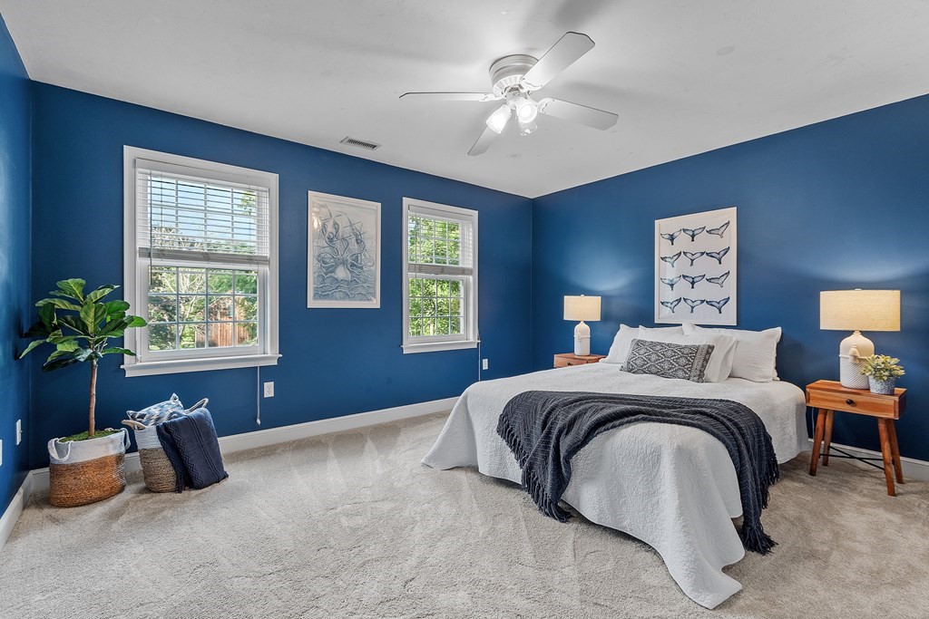 298 Old Harvard Road Boxborough, MA 01719 - Photo 23 of 42 a spacious bedroom with a bed and a chandelier