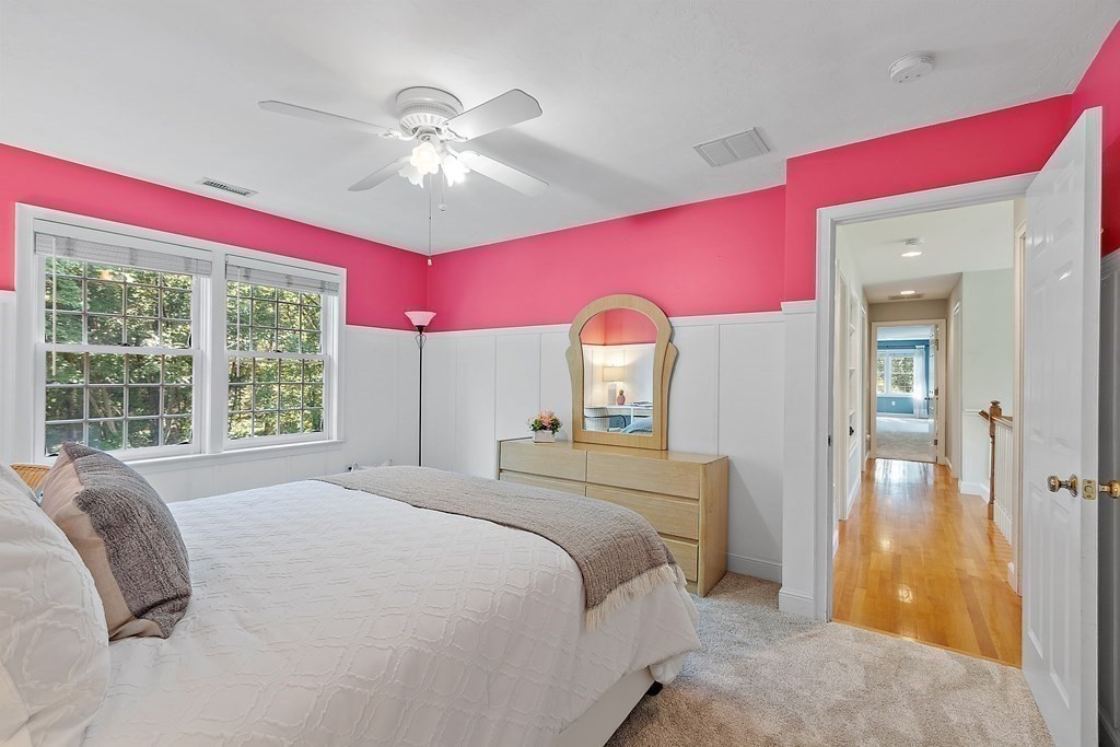 298 Old Harvard Road Boxborough, MA 01719 - Photo 24 of 42 a bedroom with a bed and a chandelier
