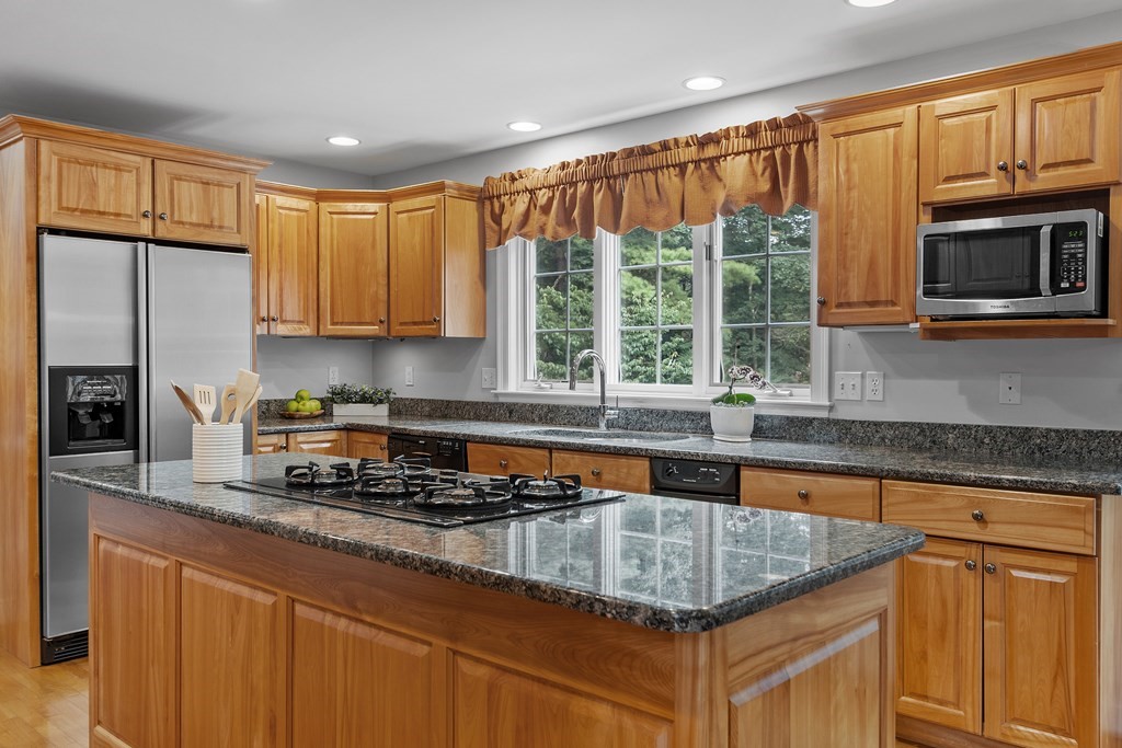 298 Old Harvard Road Boxborough, MA 01719 - Photo 9 of 42 a kitchen with counter top oven a sink and a refrigerator