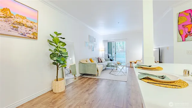 a dining room with furniture and a potted plant