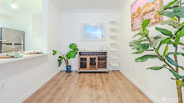 a view of a hallway with wooden floor and front door