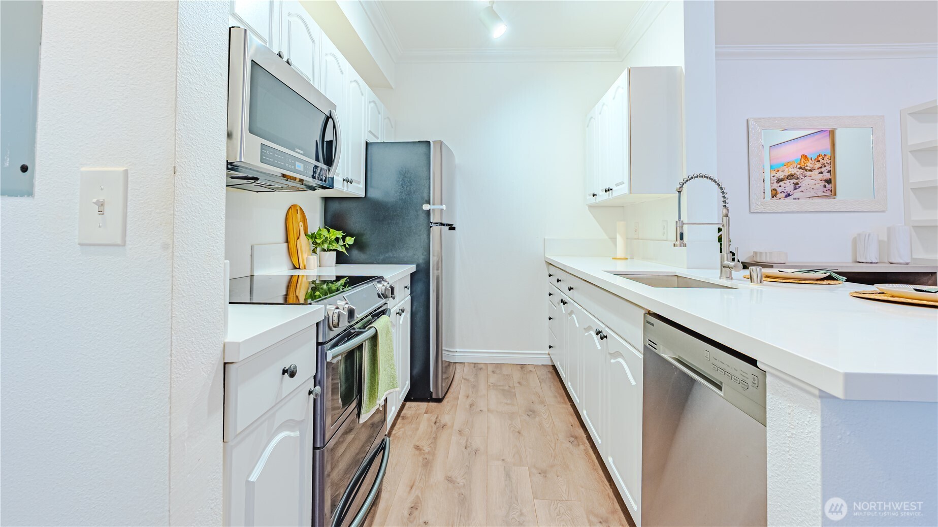 801 Rainier Avenue North, Unit G234 Renton, WA 98057 - Photo 6 of 18 a kitchen with stainless steel appliances a sink stove and refrigerator