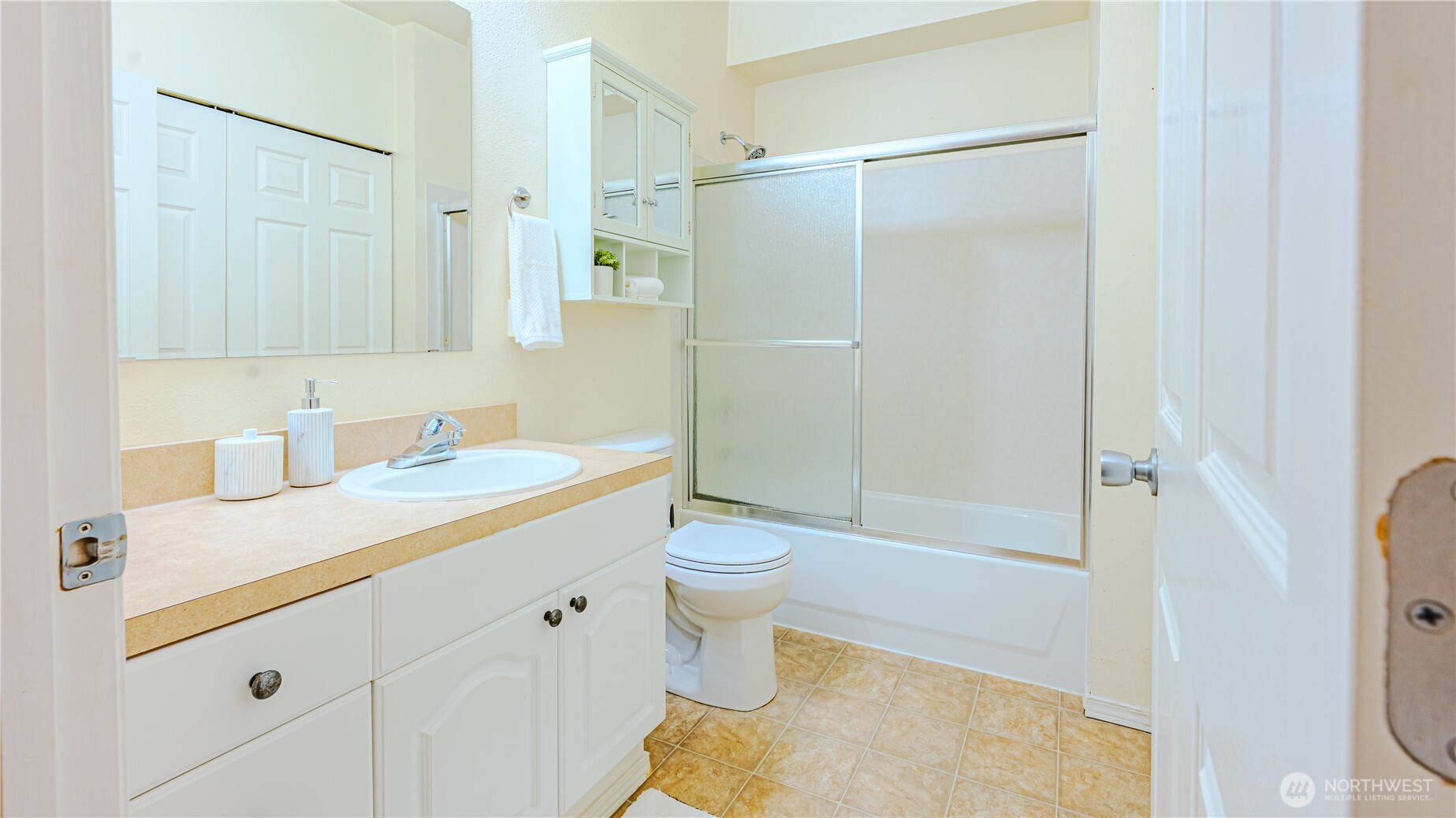 801 Rainier Avenue North, Unit G234 Renton, WA 98057 - Photo 10 of 18 a bathroom with a sink a toilet and shower
