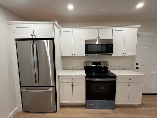 a kitchen with a refrigerator stove and microwave