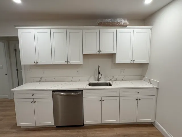 a kitchen with white cabinets