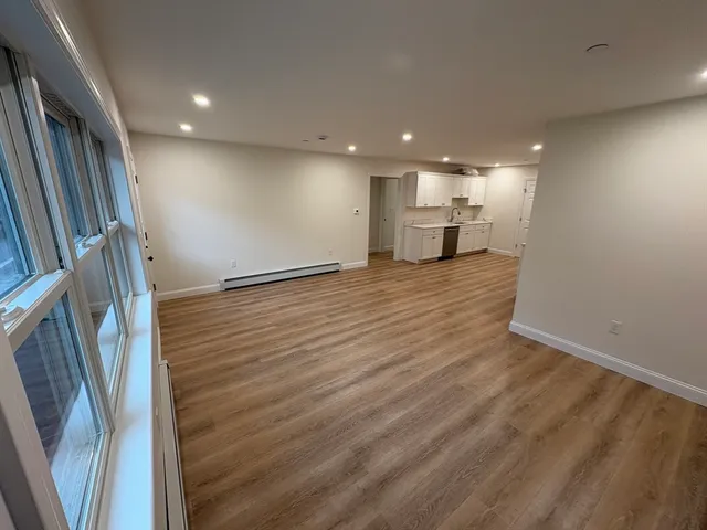 a view of a kitchen with a sink and wooden floor