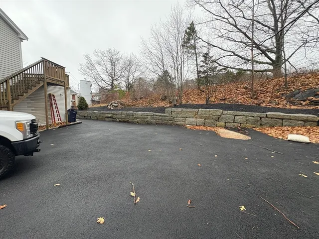a view of a house with a yard and sitting area