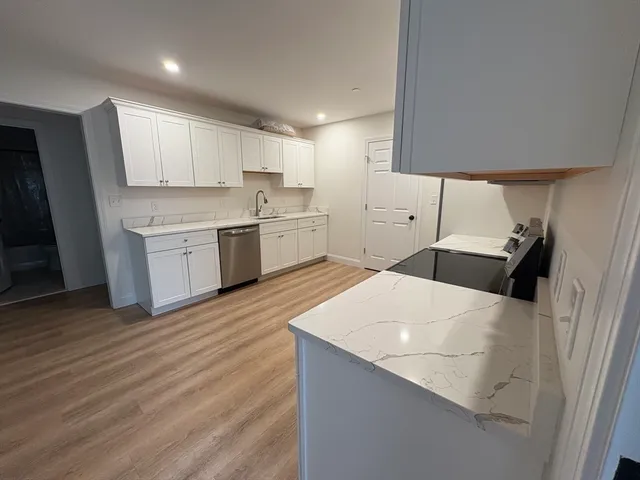 a kitchen with a sink a stove and refrigerator