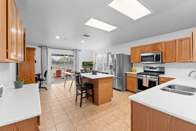 a kitchen with a sink a counter top space a stove and cabinets