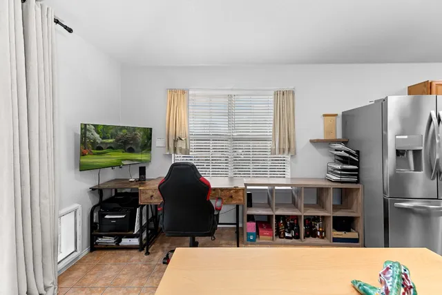 a living room with furniture a flat screen tv and large window