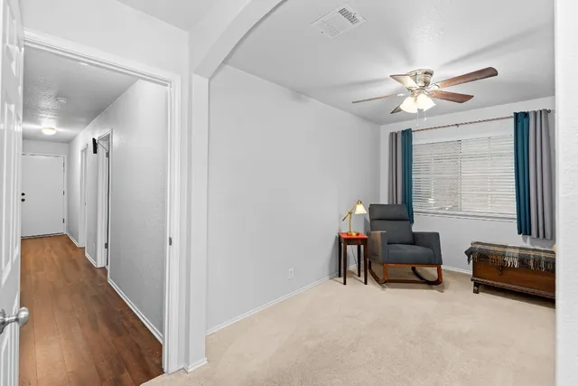a view of a livingroom with workspace and a window