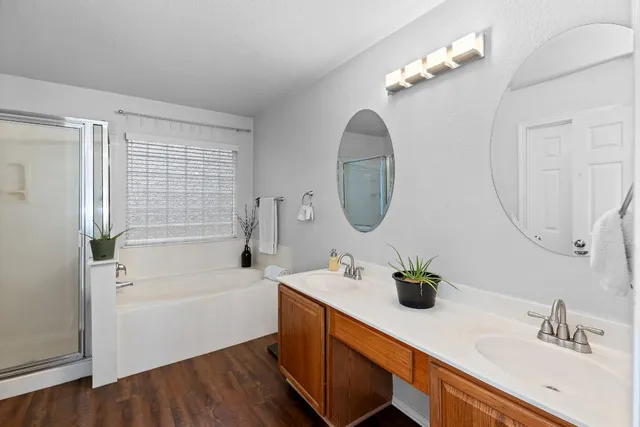 a bathroom with a bathtub sink and a mirror