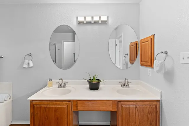 a bathroom with a double vanity sink and a mirror