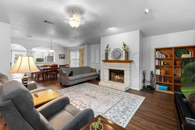 a living room with furniture fireplace and window