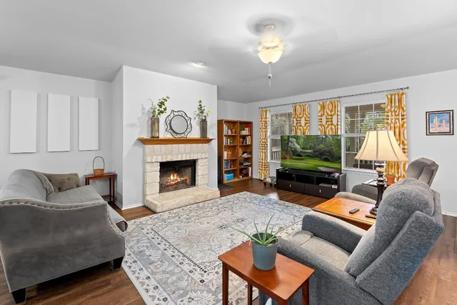 a living room with furniture a fireplace and a flat screen tv