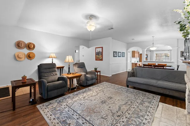 a living room with furniture and wooden floor