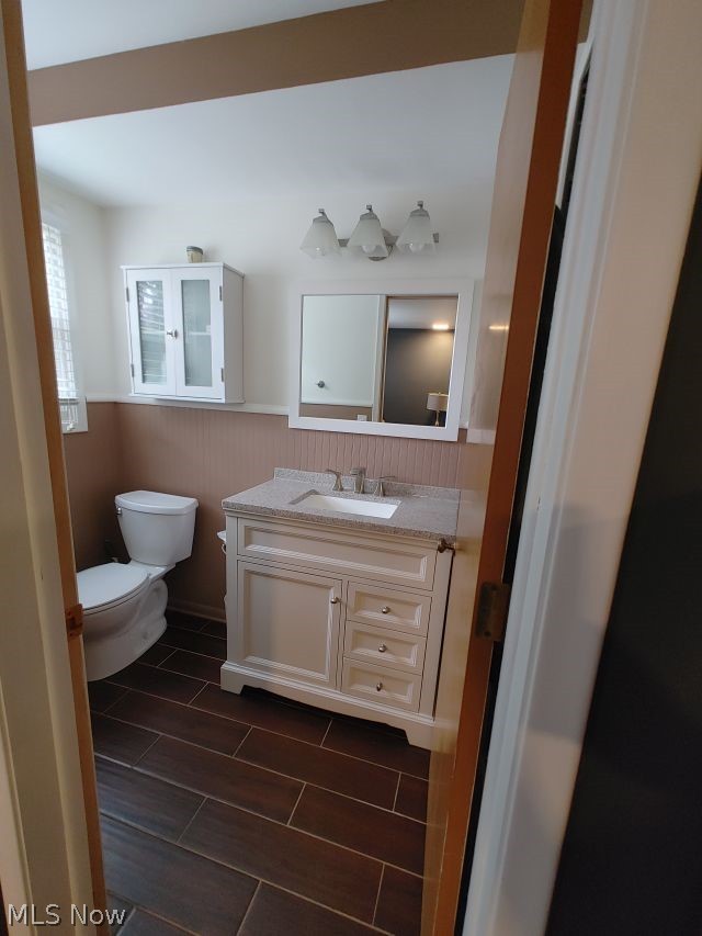2211 Devonshire Road Northwest Canton, OH 44708 - Photo 22 of 36 Bathroom with tile flooring, toilet, and vanity with extensive cabinet space