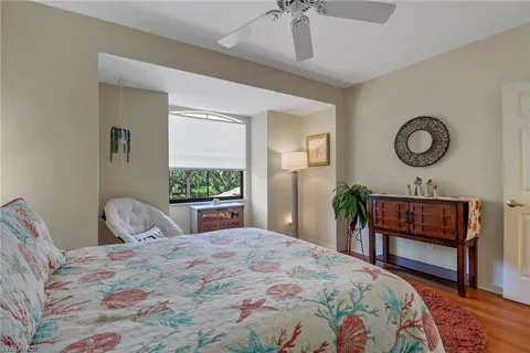 a bedroom with a bed a dresser and chair