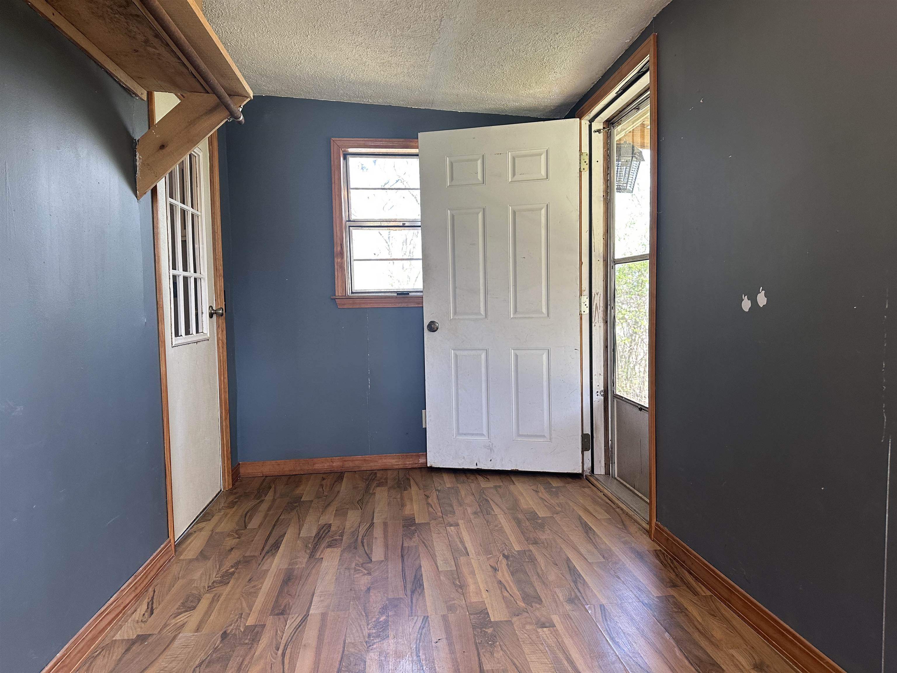 65 Cooksey Lane Michie, TN 38357 - Photo 16 of 40 an empty room with wooden floor and windows