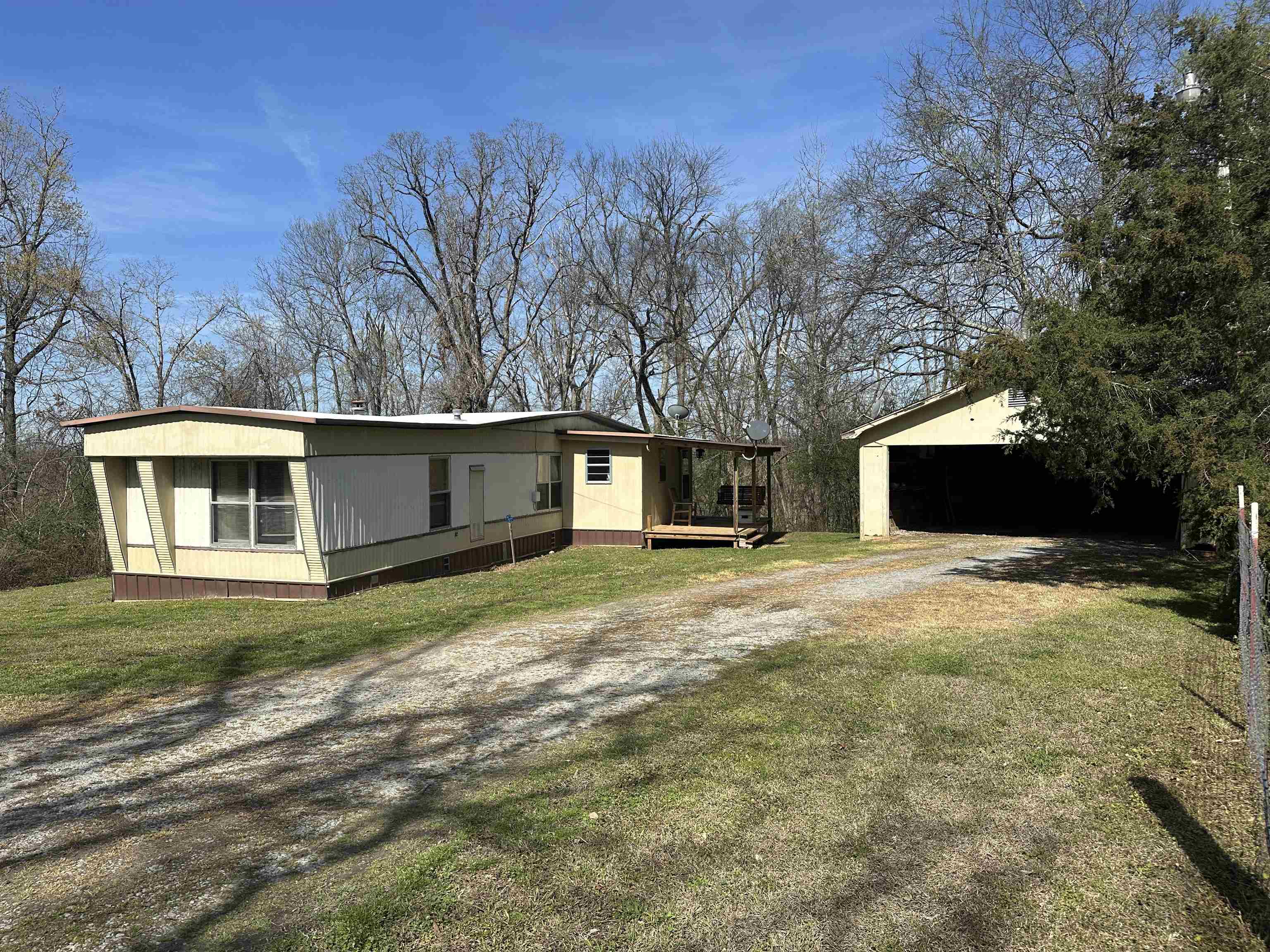 65 Cooksey Lane Michie, TN 38357 - Photo 20 of 40 a front view of a house with a yard and garage