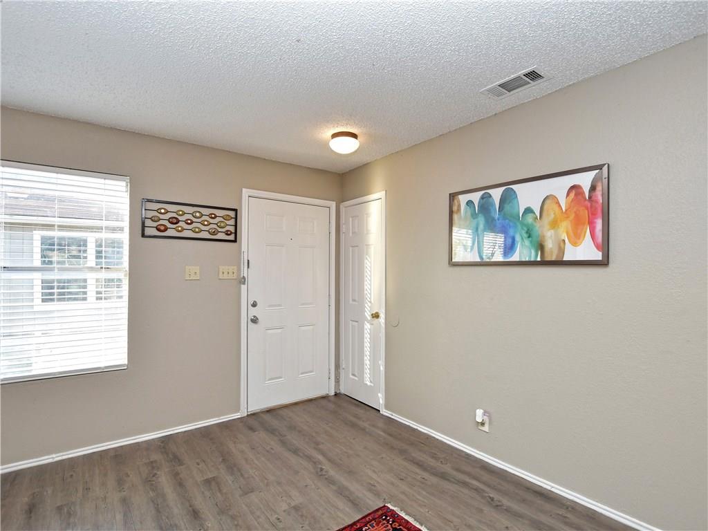 5401 Spring Meadow Road, Unit B Austin, TX 78744 - Photo 1 of 21 Natural light filters into the welcoming entrance, highlighting durable flooring and ready access.