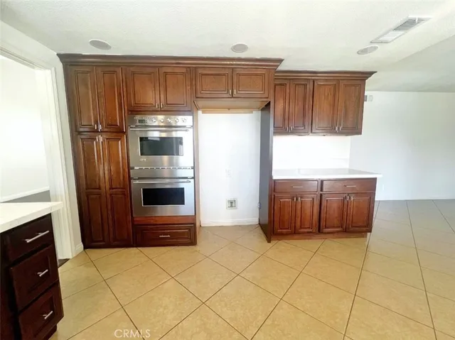 a kitchen with a sink and a stove top oven