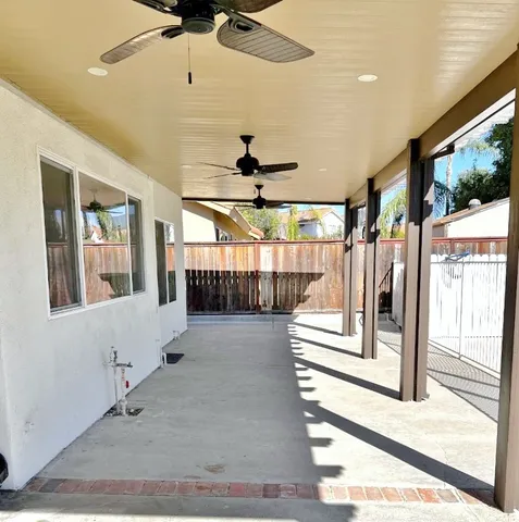 a view of staircase with lots of frames on wall and a large window