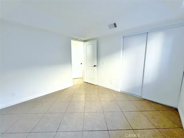 a view of a room with wooden floor and windows