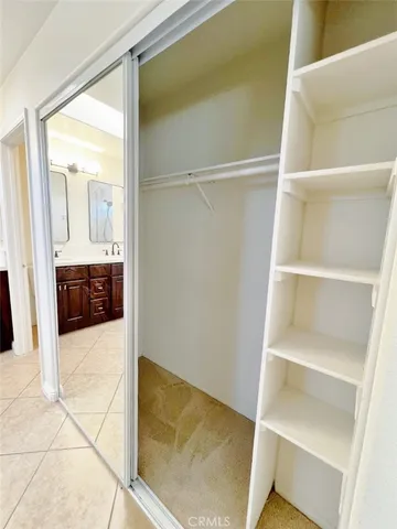 a view of a house with a yard potted plants and a table