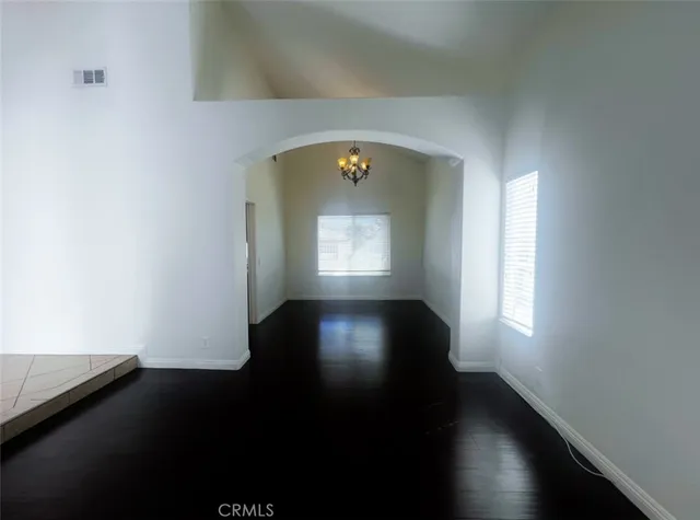 a view of a room with wooden floor and a window
