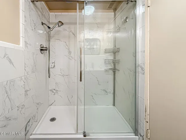 a bathroom with a glass shower door