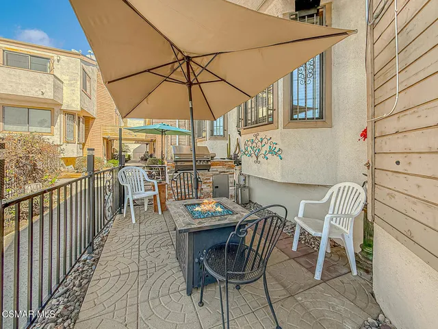 a balcony with a table and chairs