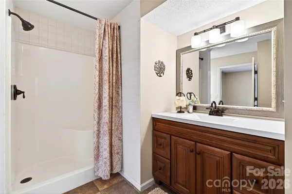 a view of an empty room with closet and entryway