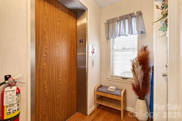 a view of empty room with wooden floor and fireplace