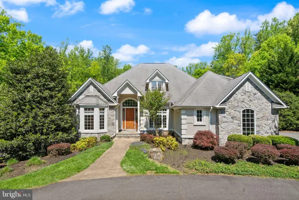 a front view of a house with a garden and plants