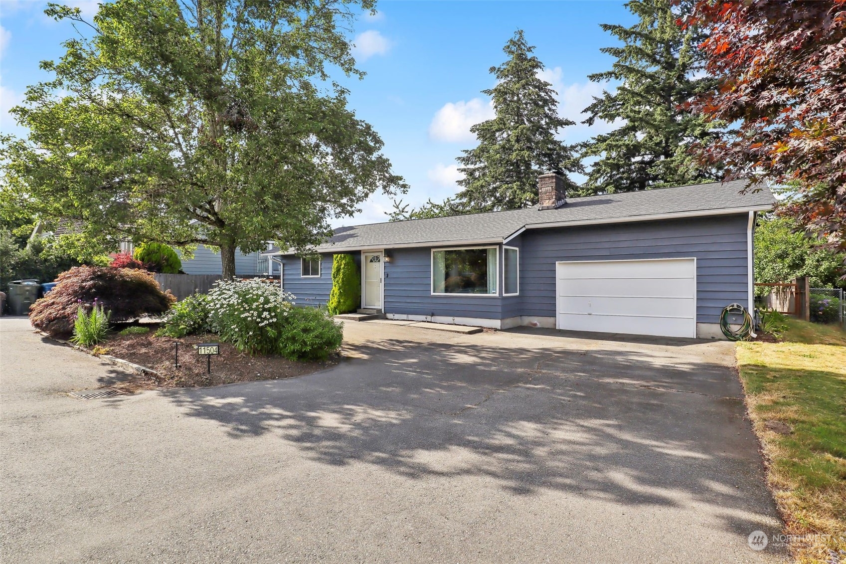 11504 Southeast 178th Place Renton, WA 98055 - Photo 1 of 30 a front view of house with yard and trees around