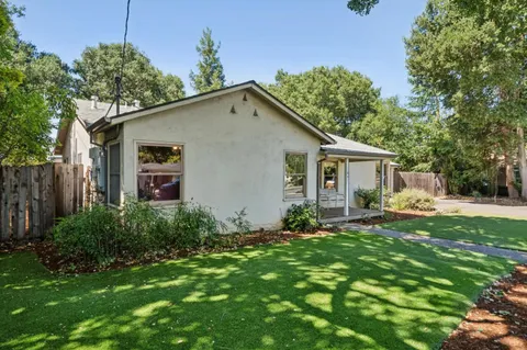 a front view of house with backyard and green space