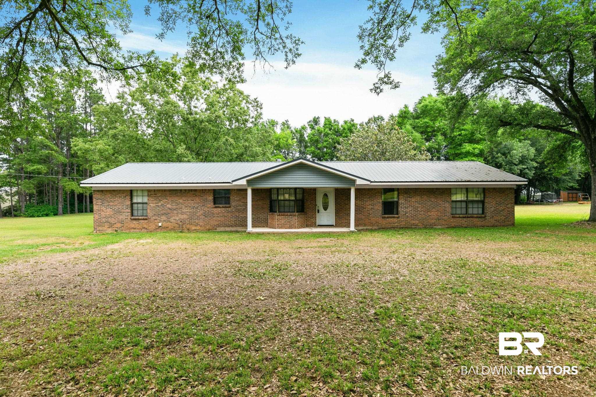 13653 Roberts Road Loxley, AL 36551 - Photo 4 of 33 Brick ranch-style exterior with a gray metal roof